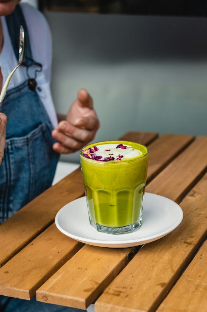 How to Make Matcha Body Scrub for Silky Smooth Skin – matcha tea , Green Tea recipe, Coffee, matcha recipes DIY matcha body scrub recipe ingredients including matcha powder, coconut oil, honey and sea salt arranged on marble surface
